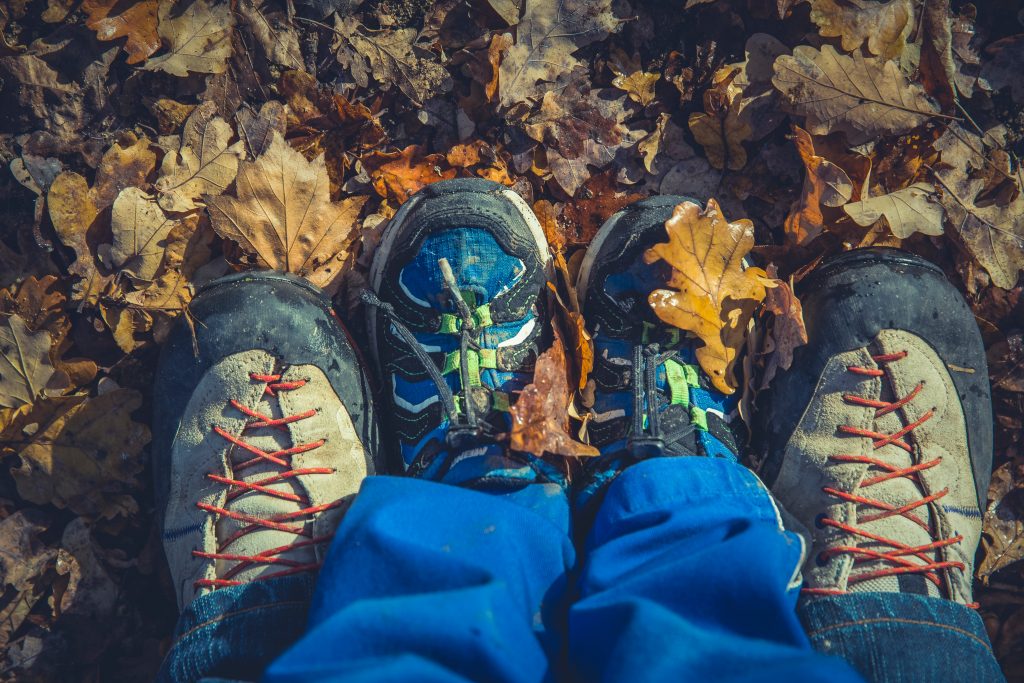 An adult and a child wearing boots