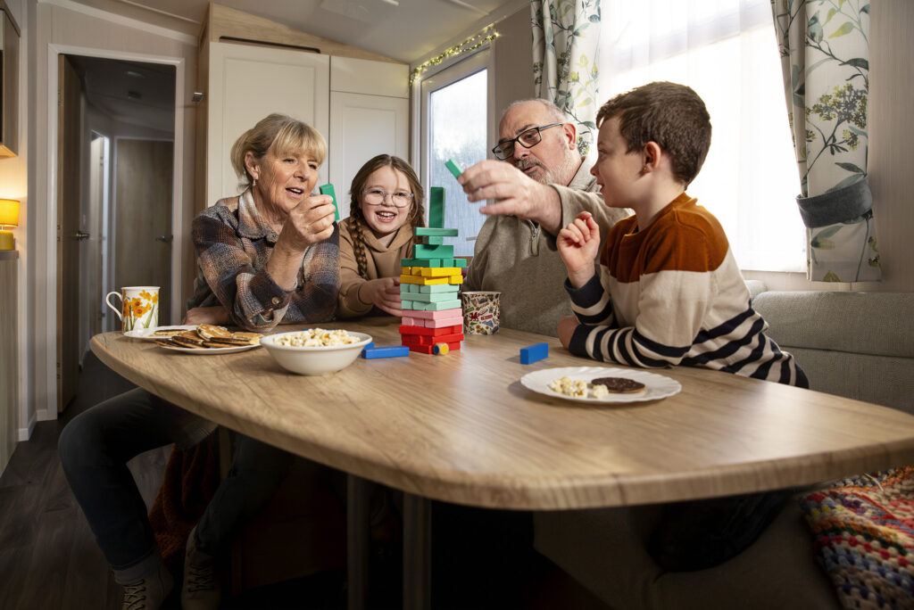 Family sitting at a caravan table